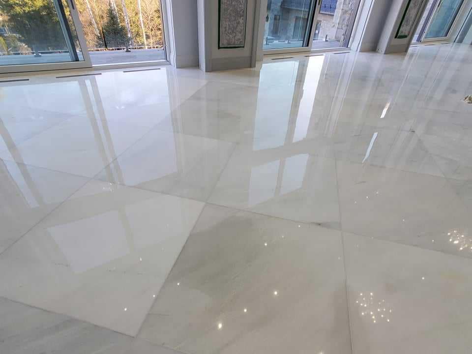 Full floor grinding in progress on a luxury marble installation